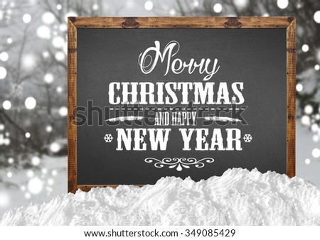 Merry Christmas and Happy New Year on blank blackboard with blur forest and snow