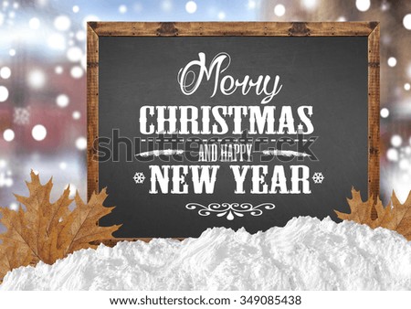 Merry Christmas and Happy New Year on blank blackboard with blurr city leaves and snow