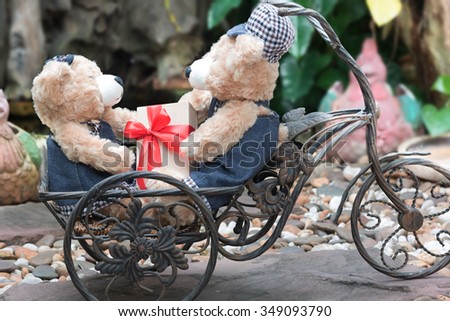 couple teddy bears with a bicycle on garden background,  two teddy bear picnic in garden love concept vintage style