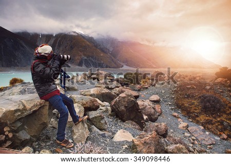 photographer taking a photo in aoraki-mt.cook national park important destination in south island new zealand