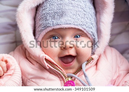 Portrait of baby girl in winter jacket and hat