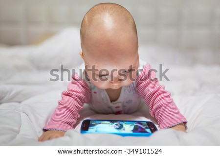 Baby girl watching cartoon on the mobile phone