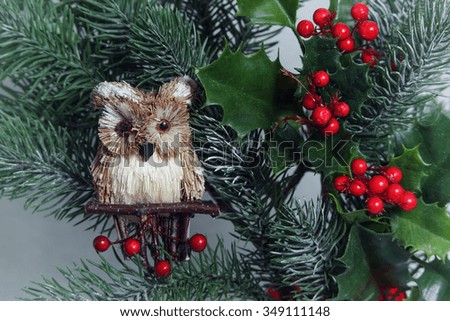 Christmas background with a toy owl and tree branches.Toned image. Vintage style.Selective focus. Horizontal