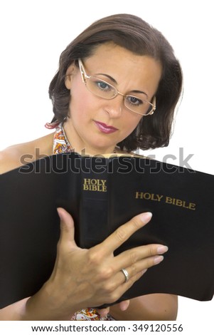 Beautiful woman with glasses reading holy bible. Open bible. Isolated