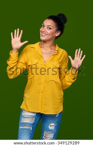 Hand counting - ten fingers. Happy playful mixed race african american - caucasian woman indicating the number ten with her fingers