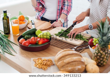 Gorgeous young Women preparing dinner in a kitchen concept cooking, culinary, healthy lifestyle Royalty-Free Stock Photo #349133213