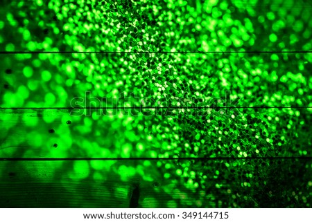 abstract circular bokeh background of Christmas light on wooden texture
