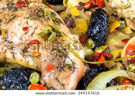 Healthy food, stewed dietary rabbit meat with various vegetables and fruit in pan, close-up, top view.