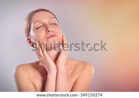 Beautiful woman touching perfect skin face. Healthy skin care concept