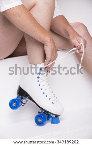 Woman lacing up a quad skate boot
