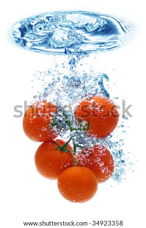 A tomato splashing into water against a white background.