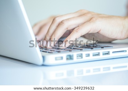 Asian business woman using laptop for online shopping.Vintage tone,Retro filter effect,Soft focus,Low light.(selective focus)