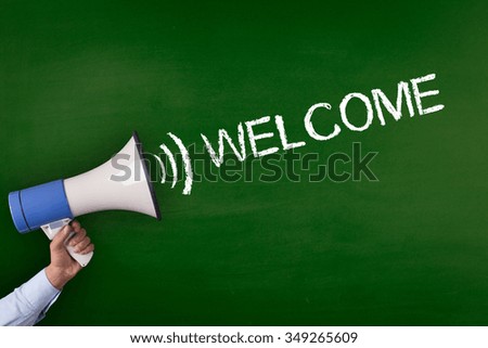 Hand Holding Megaphone with WELCOME Announcement