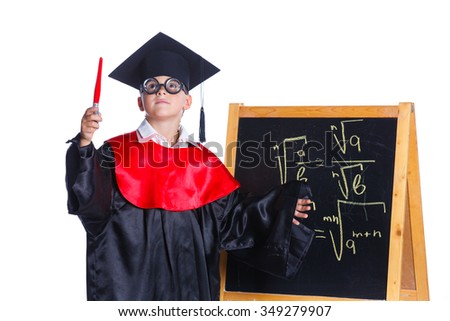 Little boy in academic hat doing complex math on black chalkboard. Isolated on a white background