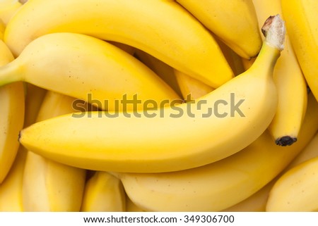 Closeup of a bundle of bananas in natural light Royalty-Free Stock Photo #349306700