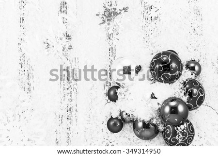 New year theme: Christmas tree balls, snow, snowflakes, serpentine on white retro stylized wood background black and white