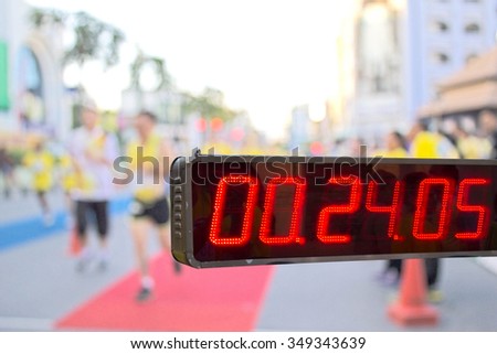 stopwatch on background blur photo of runners in Thailand Fathers Day