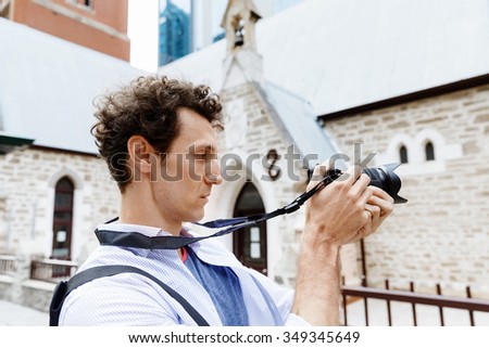 Professional photographer taking picture in city