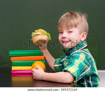 portrait schoolboy while having lunch during