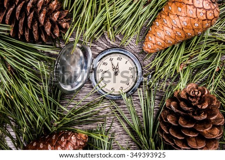 Christmas background with clock among fir tree, and cones. Image for banners, Advertising, and blogs.