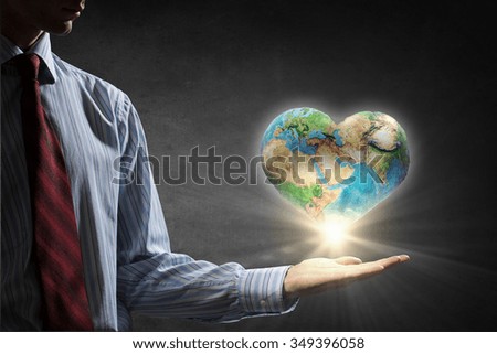 Businessman hands holding Earth planet. Elements of this image are furnished by NASA