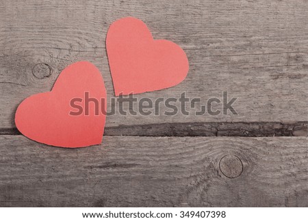 two red hearts on old wooden background