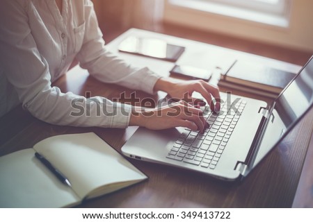 Businesswoman typing on laptop at workplace Woman working in home office hand  keyboard Royalty-Free Stock Photo #349413722