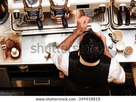 Barista and coffee machines, vintage filter applied Royalty-Free Stock Photo #349458818
