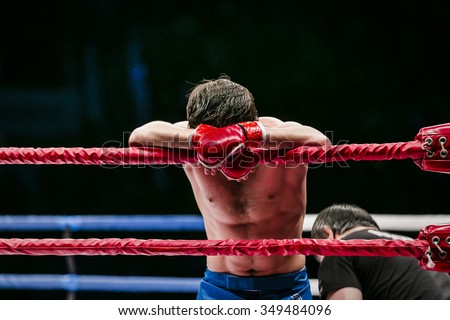 mixed martial arts fighter (MMA) stands in corner ring. lost fight. defeat of an opponent Royalty-Free Stock Photo #349484096