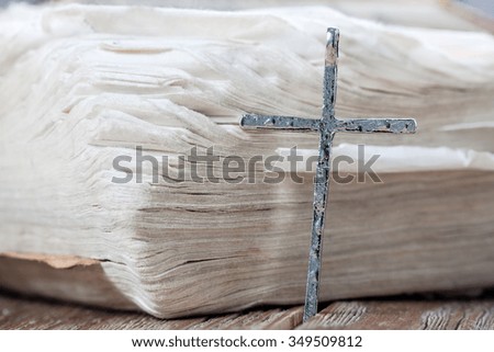 Silver christian cross on bible. Religious concept.