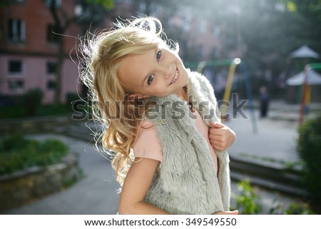 Portrait of a beautiful blonde girl outside, lifestyle