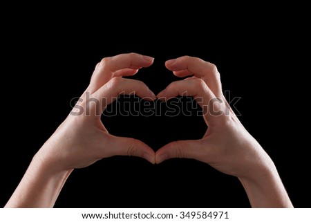 Gesture, beautiful hands young woman showing symbol of heart and love