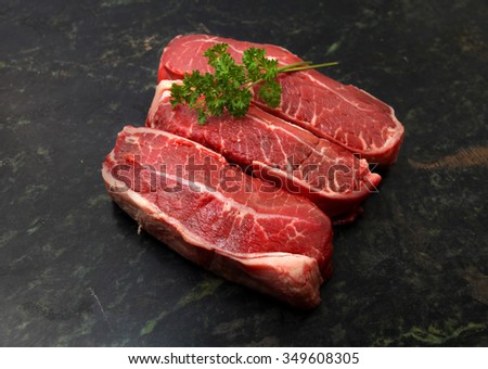 Fresh raw beef lamb fillet over marble stone chopping board Royalty-Free Stock Photo #349608305