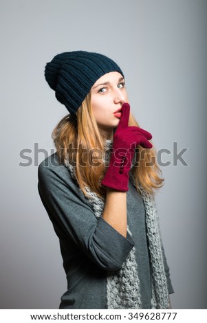 blonde girl showing quiet Christmas and New Year concept studio photo isolated on a gray background