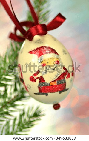 Christmas bauble made by decoupage technique on bokeh background