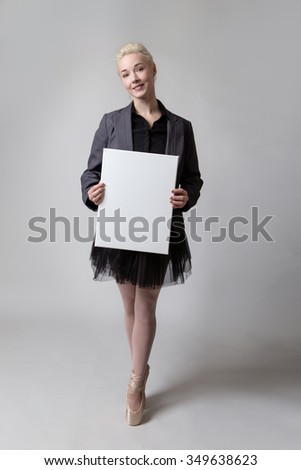 Ballerina model holding a large blank card for an advert