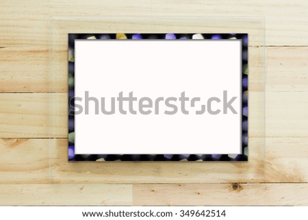 Transparent glass frame on wooden background with place for your text.