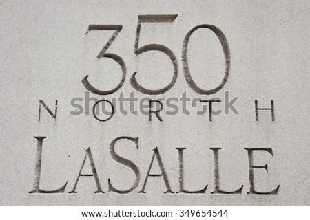 Name of 350 North La Sale Street carved on a concrete stone wall for people's convenience in Chicago, Illinois. The color of the wall in the picture is white.