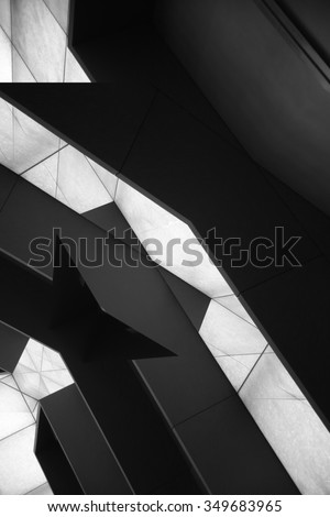 Inclined steel beams / pillars / girders / balks / bars supporting roof of modern building. A result of double exposition of black and white wall panels. Realistic tilt photo of fictional architecture