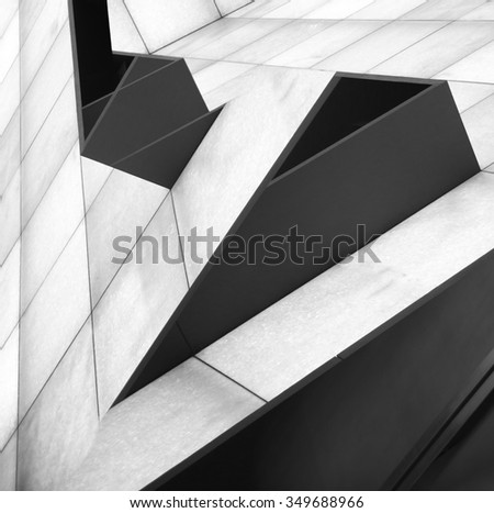Double exposure tilt photo of walls consisting of rectangular white and black panels after digital alteration which transformed snapshots into notable architecture project resembling shelves on slopes