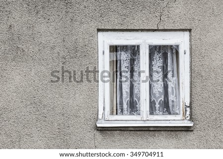 Single window in gray concrete wall texture.