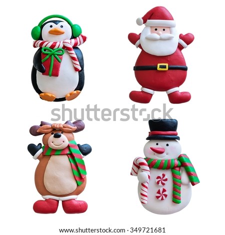Different funny clay Christmas decorations ( reindeer, Santa Claus,penguin,snowman  ) on a white background . 
