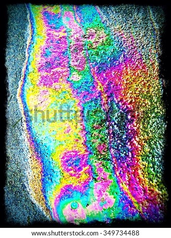 Vivid rainbow colours made by oil on a wet road