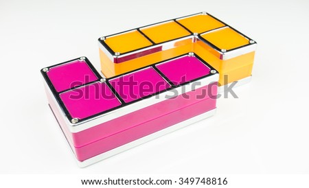 Bright color geometric shapes of four square blocks. Concept of creative thinking or problem solving. Isolated on white background. Slightly de-focused and close-up shot. Copy space.