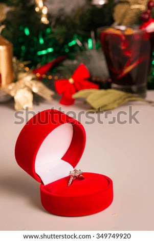 Wedding Ring among Christmas Decorations on white background. Selective Focus. 