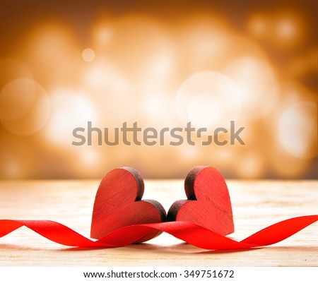 Two wooden hearts and red ribbon. Background for Valentines Day. Royalty-Free Stock Photo #349751672
