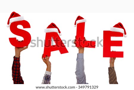 Christmas Sale. Many Hands holding a cards with the word Sale with Santa hat isolated on white background 