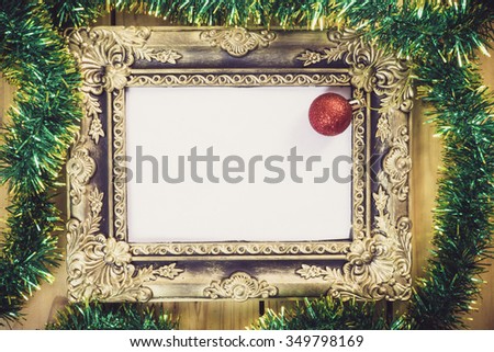 Christmas decoration with picture frame on wooden background.