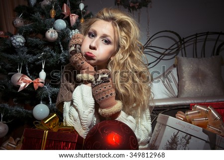 Portrait of an attractive girl in winter clothes with gifts for Christmas