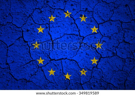 European union flag painted on dry cracked soil texture background. 